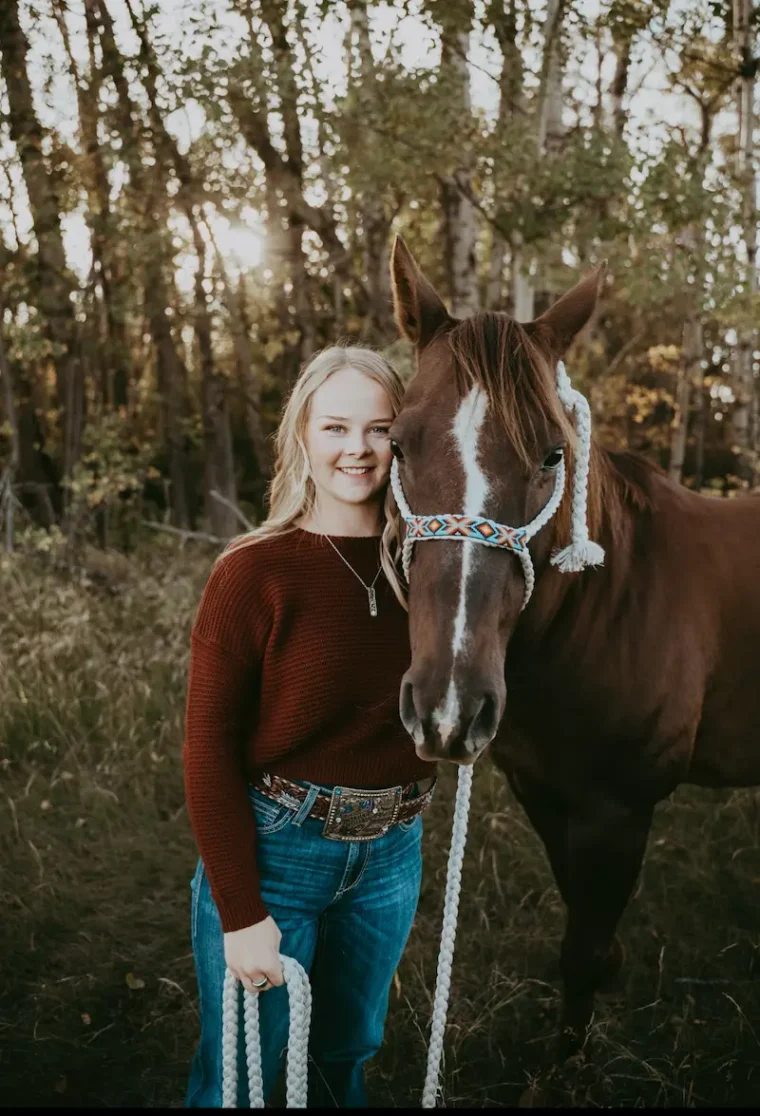Woman standing beside horse.